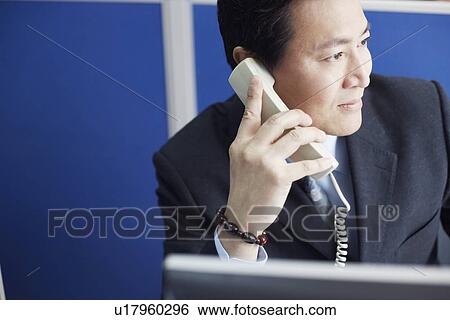 Stock Photograph - Close-up of a businessman talking on the telephone. Fotosearch