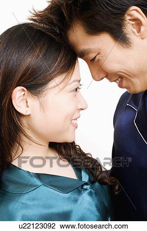 Stock Image - Close-up of a couple smiling. Fotosearch