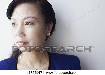 Close-up of a mature woman looking sideways thinking View Large Photo Image Stock Image - Close-up of a mature woman looking sideways thinking. Fotosearch