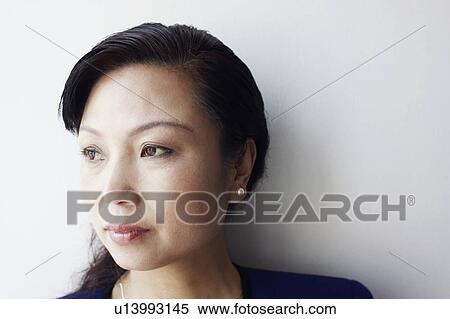 Stock Photography - Close-up of a mature woman looking sideways thinking. Fotosearch