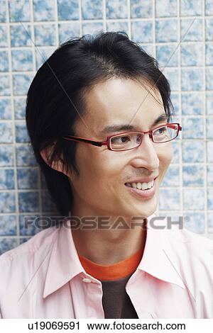 Stock Image - Close-up of a mid adult man smiling. Fotosearch