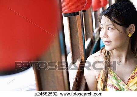 Close-up of a young woman looking out the window of a tourboat View Large Photo Image Stock Image - Close-up of a young woman looking out the window of a tourboat. Fotosearch