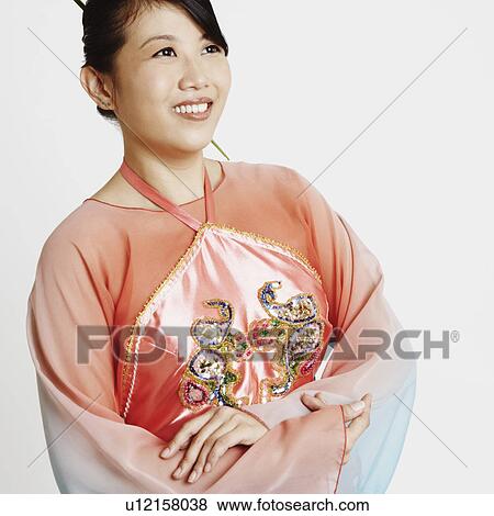 Close-up of a young woman with her arms crossed View Large Photo Image Stock Photo - Close-up of a young woman with her arms crossed. Fotosearch
