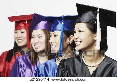 Picture - Close-up of four female graduates standing in a row. Fotosearch