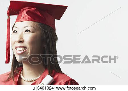 Portrait of a female graduate holding a diploma View Large Photo Image Picture - Portrait of a female graduate holding a diploma. Fotosearch