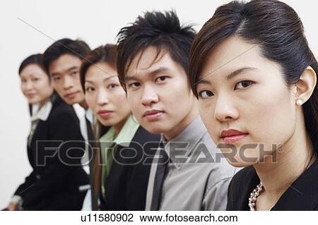 Stock Image - Portrait of three businesswomen with two businessmen. Fotosearch