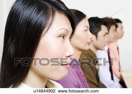 Three businessmen and two businesswomen sitting side by side View Large Photo Image Stock Image - Three businessmen and two businesswomen sitting side by side. Fotosearch