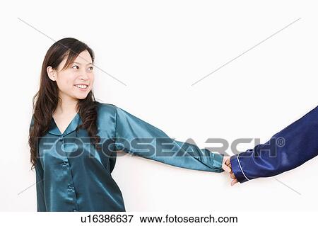 Young woman holding a man's hand and smiling View Large Photo Image Stock Photo - Young woman holding a man's hand and smiling. Fotosearch