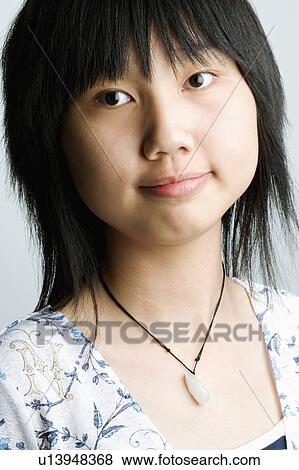 Stock Photo - Portrait of a girl smirking. Fotosearch