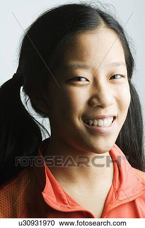 Stock Image - Portrait of a teenage girl smiling. Fotosearch