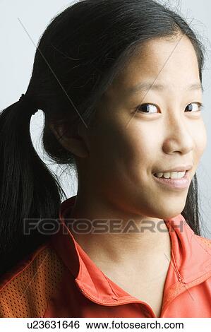 Portrait of a teenage girl smiling View Large Photo Image Stock Photograph - Portrait of a teenage girl smiling. Fotosearch