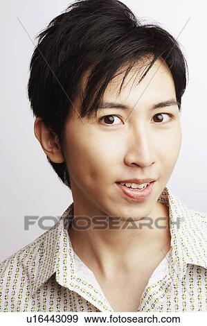 Stock Photo - Portrait of a young man smiling. Fotosearch