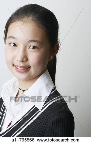 Portrait of a young woman smiling View Large Photo Image Stock Photograph - Portrait of a young woman smiling. Fotosearch