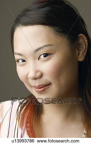 Portrait of a young woman smiling View Large Photo Image Stock Photograph - Portrait of a young woman smiling. Fotosearch