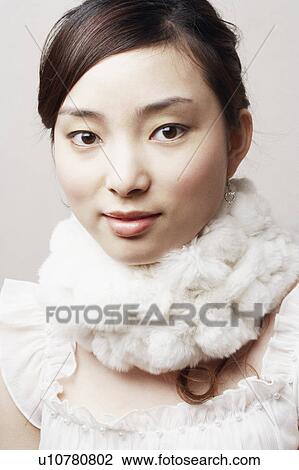 Portrait of a young woman with a feather boa around her neck View Large Photo Image Stock Image - Portrait of a young woman with a feather boa around her neck. Fotosearch