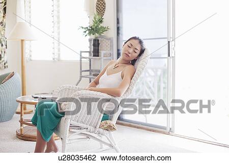 A young woman sleeping on chair View Large Photo Image Stock Image - A young woman sleeping on chair. Fotosearch