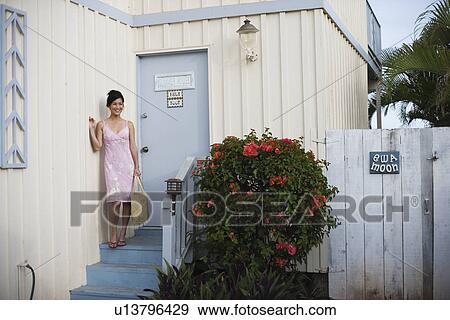 View of a woman standing near door View Large Photo Image Stock Photo - View of a woman standing near door. Fotosearch