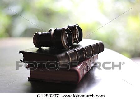 Stock Photo - Close-up of a binocular on books. Fotosearch