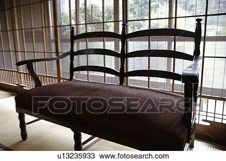 Stock Image - Close-up of a cushioned settee. Fotosearch