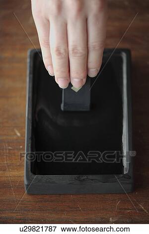 Stock Photo - Close-up of a hand mixing colors. Fotosearch