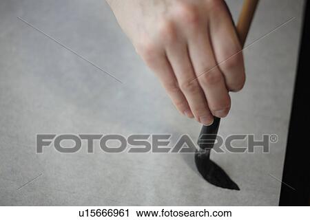 Stock Image - Person painting on a canvas. Fotosearch
