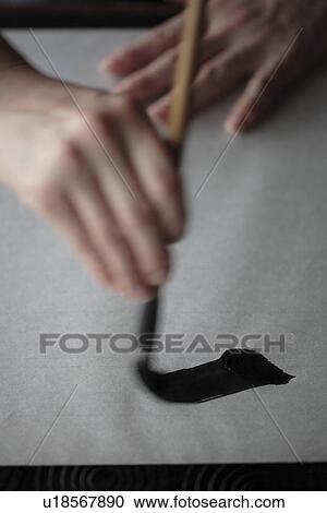 Stock Image - Person painting on a canvas. Fotosearch