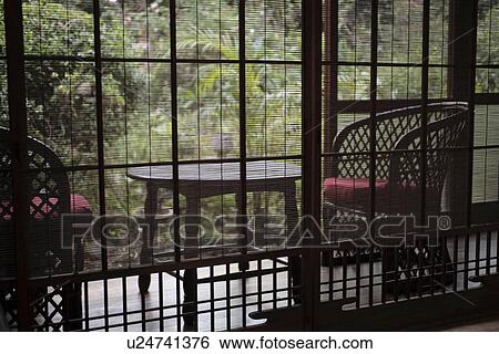 Stock Photograph - Side view of a porch through blinds. Fotosearch