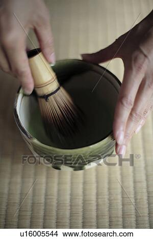 Picture - View of a person grinding with a pestle. Fotosearch