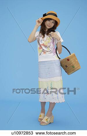 Portrait of a teenage girl holding a basket View Large Photo Image Stock Image - Portrait of a teenage girl holding a basket. Fotosearch