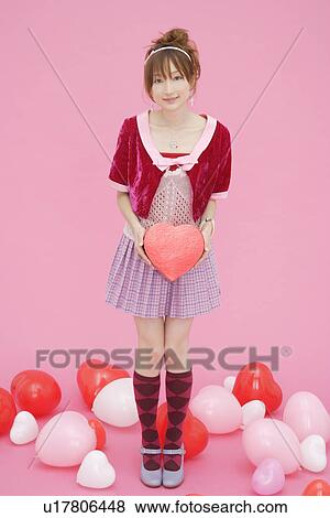 Stock Photo - Portrait of a teenage girl holding a gift box. Fotosearch