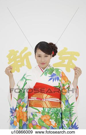 Portrait of a teenage girl holding Japanese alphabets View Large Photo Image Stock Photo - Portrait of a teenage girl holding Japanese alphabets. Fotosearch