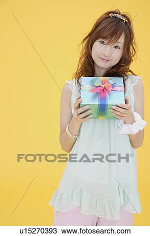 Portrait of a teenage girl with a gift box View Large Photo Image Stock Image - Portrait of a teenage girl with a gift box. Fotosearch