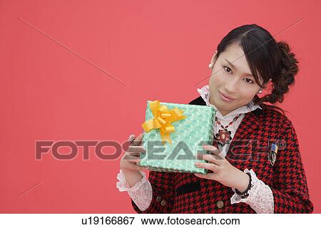 Stock Photo - Portrait of a teenage girl with a gift box. Fotosearch