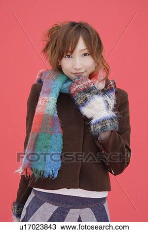 Stock Image - Portrait of a teenager girl wearing a muffler. Fotosearch