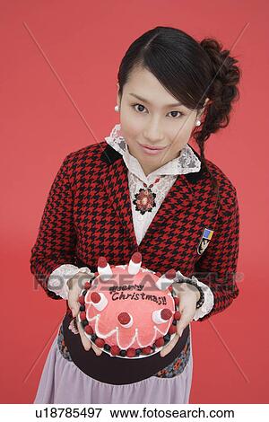 View of teenage girl holding a birthday cake View Large Photo Image Stock Photo - View of teenage girl holding a birthday cake. Fotosearch