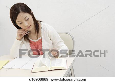 View of a young woman studying View Large Photo Image Stock Photo - View of a young woman studying. Fotosearch