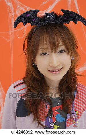 Stock Image - Close-up of teenage girl wearing a headdress. Fotosearch