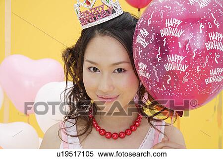 Portrait of a teenage girl holding a balloon View Large Photo Image Stock Photography - Portrait of a teenage girl holding a balloon. Fotosearch