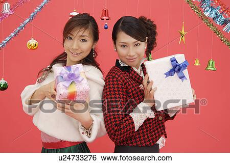 Portrait of teenage girls holding boxes View Large Photo Image Stock Photograph - Portrait of teenage girls holding boxes. Fotosearch