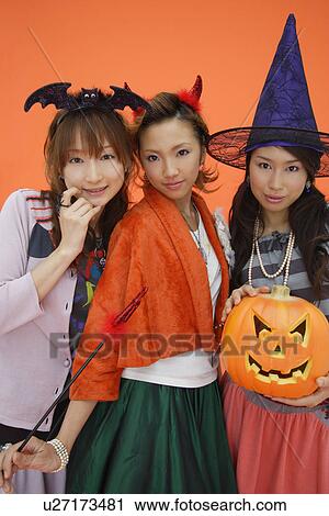 Teenage girls with jack-o-lantern View Large Photo Image Stock Image - Teenage girls with jack-o-lantern. Fotosearch