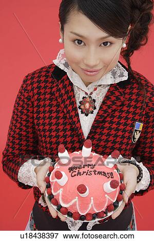 View of teenage girl holding a birthday cake View Large Photo Image Stock Photo - View of teenage girl holding a birthday cake. Fotosearch