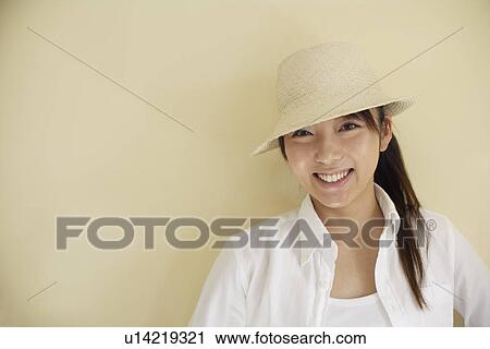 Portrait of a young woman wearing hat View Large Photo Image Stock Image - Portrait of a young woman wearing hat. Fotosearch
