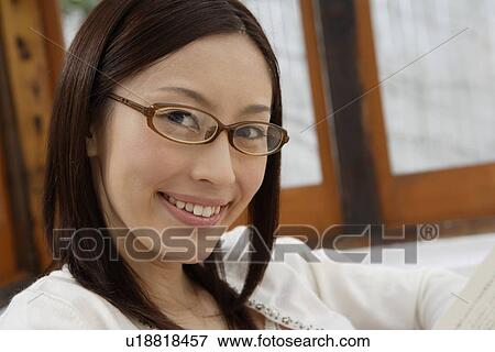 View of a young woman smiling View Large Photo Image Stock Photo - View of a young woman smiling. Fotosearch