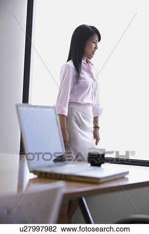 A woman staring over something from the window View Large Photo Image Stock Image - A woman staring over something from the window. Fotosearch