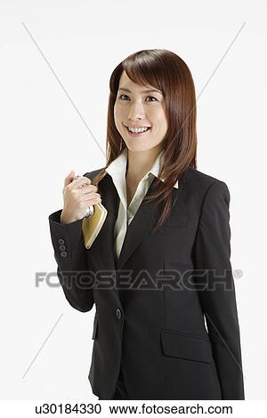 Businesswoman holding a diary, portrait View Large Photo Image Stock Image - Businesswoman holding a diary, portrait . Fotosearch