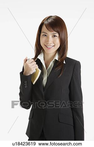 Stock Photo - Businesswoman holding a diary, portrait . Fotosearch