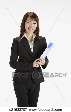 Stock Photo - Businesswoman holding a file, portrait. Fotosearch