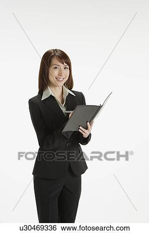 Stock Photograph - Cheerful executive holding a file, portrait. Fotosearch