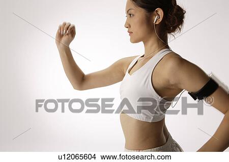 Close-up of a young woman exercising View Large Photo Image Picture - Close-up of a young woman exercising. Fotosearch