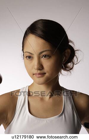 Close-up of a young woman exercising View Large Photo Image Stock Image - Close-up of a young woman exercising. Fotosearch